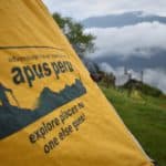 yellow tent with apus peru logo on it